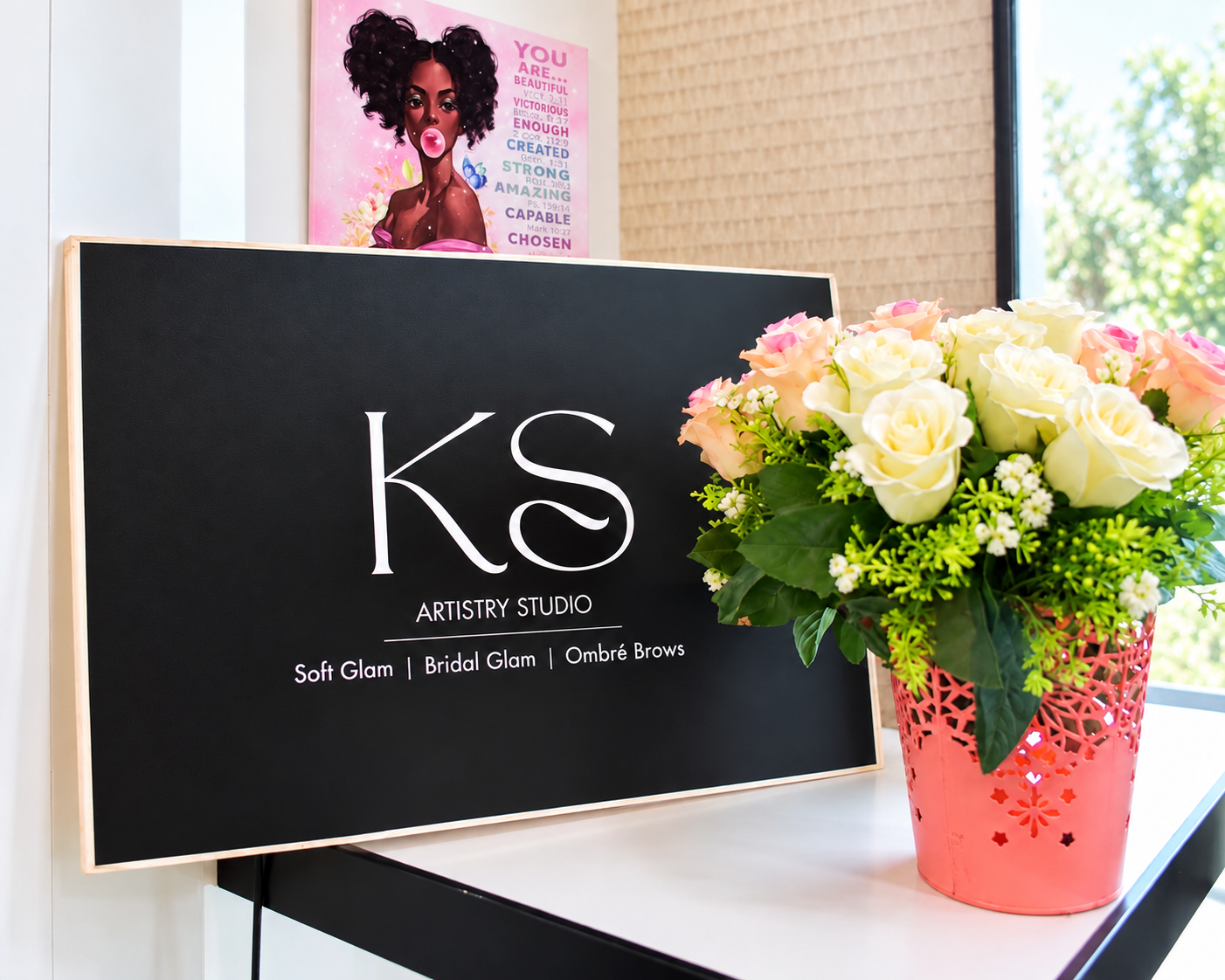 KS Artistry Studio sign and flowers inside the studio